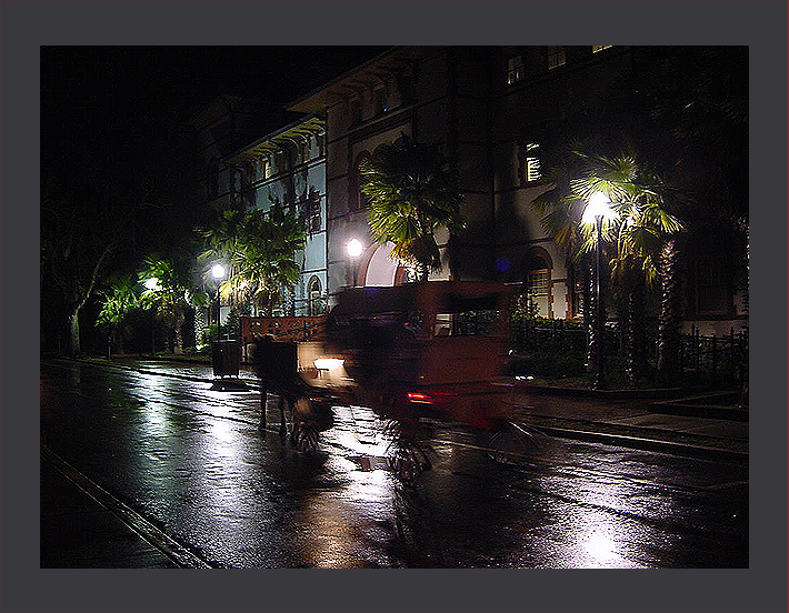 Horse carriage on a wet St. Augustine side road at night.
